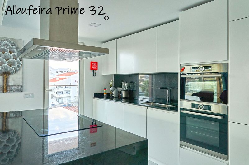 Kitchen with a glass door out to the lower terrace